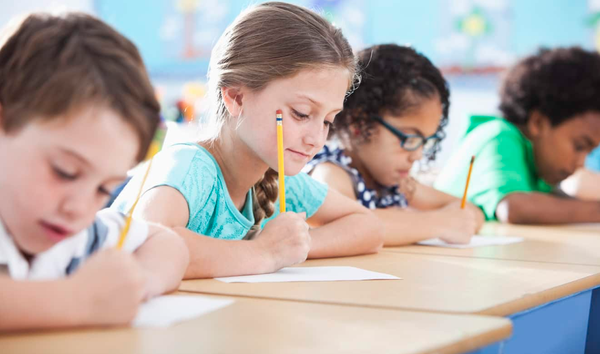 Children writing at desk.PNG